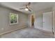 Bedroom features neutral paint, carpet, and a natural light source at 12434 Cody Dr, Wimauma, FL 33598