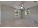 Bright bedroom with neutral carpet, ceiling fan, and natural light provides a serene and inviting atmosphere at 12434 Cody Dr, Wimauma, FL 33598