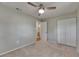 This bedroom offers neutral colors and a ceiling fan for a comfortable atmosphere at 12434 Cody Dr, Wimauma, FL 33598