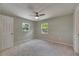 The bedroom features neutral paint, carpet, and a ceiling fan at 12434 Cody Dr, Wimauma, FL 33598