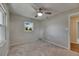 Bedroom features neutral carpet, ceiling fan, and natural light providing comfort and functionality at 12434 Cody Dr, Wimauma, FL 33598