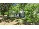 Charming single-story home with a metal roof, quaint shutters, and a well-maintained lawn at 12434 Cody Dr, Wimauma, FL 33598