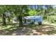 Charming single-story home featuring a metal roof and mature trees in a peaceful, private setting at 12434 Cody Dr, Wimauma, FL 33598