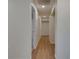 Hallway features wood-look flooring, neutral paint, and recessed lighting for a modern, streamlined aesthetic at 12434 Cody Dr, Wimauma, FL 33598