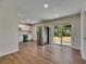 Bright kitchen boasts stainless steel appliances, white cabinetry, and a sliding door to the backyard at 12434 Cody Dr, Wimauma, FL 33598