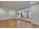 Bright living room features beautiful wood flooring, recessed lighting, and an open floor plan at 12434 Cody Dr, Wimauma, FL 33598