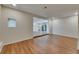 Bright living room features beautiful wood flooring, recessed lighting, and an open floor plan at 12434 Cody Dr, Wimauma, FL 33598