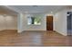 Living room showcasing new floors, a large window, and a beautiful wood front door at 12434 Cody Dr, Wimauma, FL 33598