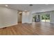 Bright living room with new floors, stainless refrigerator, and large window at 12434 Cody Dr, Wimauma, FL 33598