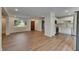 Open living space featuring new floors and a view of the kitchen and front door at 12434 Cody Dr, Wimauma, FL 33598