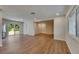Spacious living room with new floors, neutral walls, and sliding glass doors to the yard at 12434 Cody Dr, Wimauma, FL 33598