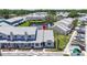 Aerial view of cozy townhomes with well-maintained landscaping and parking spaces, near a tranquil pond at 12648 Castle Hill Dr, Tampa, FL 33624