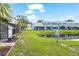 Exterior view of backyard and pond behind blue Townhouse style home at 12648 Castle Hill Dr, Tampa, FL 33624