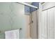 Bathroom featuring a shower with a patterned glass door, as well as shelving at 12648 Castle Hill Dr, Tampa, FL 33624