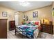Cozy bedroom with light floors, a colorful quilt, and charming decorative accents at 12648 Castle Hill Dr, Tampa, FL 33624