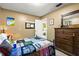 Cozy bedroom with wood-look floors, and a wooden dresser at 12648 Castle Hill Dr, Tampa, FL 33624