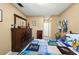 Bedroom featuring a wood dresser, unique quilt, and neutral walls at 12648 Castle Hill Dr, Tampa, FL 33624