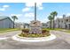 Hampton Park Townhomes entrance with a deed restricted community sign surrounded by beautiful flowers at 12648 Castle Hill Dr, Tampa, FL 33624