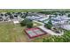 Birds-eye view of a recreational area with tennis and basketball courts, a playground, and green spaces at 12648 Castle Hill Dr, Tampa, FL 33624