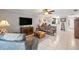 Inviting living room with tile flooring, a ceiling fan, comfortable seating, and easy access to other parts of the home at 12648 Castle Hill Dr, Tampa, FL 33624