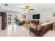 Bright living room featuring tile flooring, ceiling fan, comfortable seating, and sliding doors to the outside at 12648 Castle Hill Dr, Tampa, FL 33624
