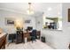 Bright office with a wooden desk, tile flooring, and direct access to the kitchen at 12648 Castle Hill Dr, Tampa, FL 33624