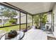 Screened patio with tile flooring, various plants, and serene outdoor view at 12648 Castle Hill Dr, Tampa, FL 33624