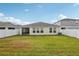 A spacious backyard featuring a well-manicured lawn and a privacy fence at 12830 Bent Twig Dr, Riverview, FL 33579