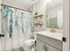 Stylish bathroom with a leafy shower curtain and gold fixtures at 12830 Bent Twig Dr, Riverview, FL 33579