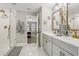 Modern bathroom featuring double vanity with gold hardware and a glass-enclosed shower with gold fixtures at 12830 Bent Twig Dr, Riverview, FL 33579