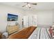 Bright bedroom with neutral walls and carpeted floors. with adjacent doors leading to other rooms at 12830 Bent Twig Dr, Riverview, FL 33579