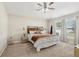 Cozy bedroom featuring neutral walls, ceiling fan and carpeted floors with two windows allowing natural light at 12830 Bent Twig Dr, Riverview, FL 33579