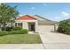 Charming single-story home with a well-manicured lawn, complemented by a two car garage and a welcoming front porch at 12830 Bent Twig Dr, Riverview, FL 33579