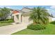 An exterior shot showcasing a well-maintained home, with a lush green lawn and mature palm trees at 12830 Bent Twig Dr, Riverview, FL 33579