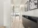 Bright hallway with modern floors and stylish wall decor, leading to the main living areas at 12830 Bent Twig Dr, Riverview, FL 33579