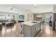 Spacious kitchen featuring stainless steel appliances, ample counter space, and an island flowing into living area at 12830 Bent Twig Dr, Riverview, FL 33579