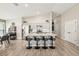 A modern kitchen featuring stainless steel appliances, gray cabinets, an island with bar stools and wood grain flooring at 12830 Bent Twig Dr, Riverview, FL 33579