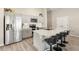 Modern kitchen with stainless steel appliances, gray cabinetry, and a large island with bar stool seating at 12830 Bent Twig Dr, Riverview, FL 33579