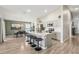 Bright kitchen with stainless steel appliances, gray cabinetry, large island with seating and adjacent dining area at 12830 Bent Twig Dr, Riverview, FL 33579
