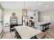 Open-concept kitchen with stainless steel appliances, gray cabinetry, island with bar seating and adjacent dining area at 12830 Bent Twig Dr, Riverview, FL 33579