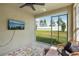 Relaxing enclosed lanai with serene backyard views and a wall-mounted television at 12830 Bent Twig Dr, Riverview, FL 33579