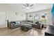Cozy living room featuring a comfortable sectional couch, large windows, and stylish decor at 12830 Bent Twig Dr, Riverview, FL 33579