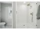 A sleek, glass-enclosed shower with white subway tile and brushed gold hardware at 12830 Bent Twig Dr, Riverview, FL 33579