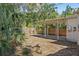 View of the backyard and covered patio with a wood fence and mature foliage at 1310 43Rd S St, St Petersburg, FL 33711