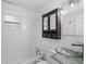 Bright bathroom featuring a glass vessel sink, updated vanity, and subway tile backsplash around the tub at 1310 43Rd S St, St Petersburg, FL 33711