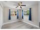 Cozy bedroom with modern flooring, ceiling fan, two bright windows, and a closet for ample storage at 1310 43Rd S St, St Petersburg, FL 33711