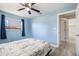 Comfortable blue bedroom with modern flooring and natural light streaming through the windows at 1310 43Rd S St, St Petersburg, FL 33711