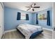 Inviting blue bedroom with modern flooring, ceiling fan, and natural light streaming through the windows at 1310 43Rd S St, St Petersburg, FL 33711
