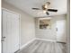 Bedroom with wood-look floors, ceiling fan, and natural light at 1310 43Rd S St, St Petersburg, FL 33711