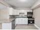 Kitchen boasts white cabinets, stainless steel appliances and countertop seating at 1310 43Rd S St, St Petersburg, FL 33711